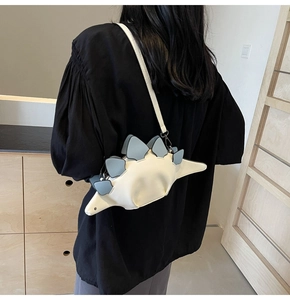 Rear view of model wearing a creative white dinosaur-shaped PU leather crossbody bag