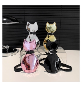 Detail view of cat-shaped crossbody bags in silver gold pink and black patent leather