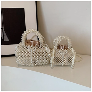 Detail of handcrafted pearl beaded handbags with satin drawstring lining and ribbon bows