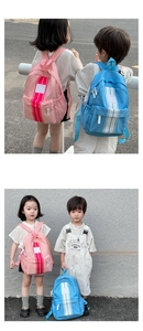 Detail showing pink and blue striped waterproof backpacks for children outdoors