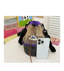 Close-up of mesh drawstring beach bag in purple and beige with adjustable strap