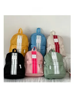 Showcase of six colorful nylon backpacks for children with vertical stripes and front pocket