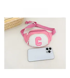 Pink and white canvas kids fanny pack shown with a smartphone for size scale