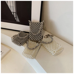 Detail of beaded mini bucket bags with pearl textures and twisted metal handles