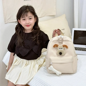 Cute beige children's backpack featuring 3D cartoon plush dog and bone charm detail