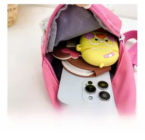 Internal view of pink chest bag showing storage for phone, earphones and notepad