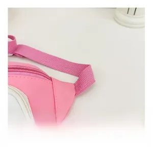 Detail shot of the pink children chest bag showing durable nylon fabric and secure stitching