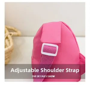 Detail of adjustable woven strap with white plastic buckle on pink kids' chest bag