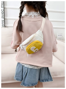Detailed view of kids crossbody bag featuring yellow and white contrast with G patch