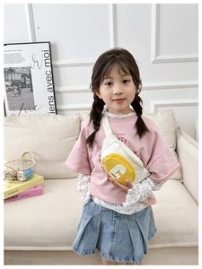 Detailed close-up of a canvas crossbody bag for kids with yellow front pocket and letter G