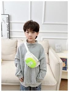 Detail of white canvas kids chest bag with neon green zip pocket and G letter
