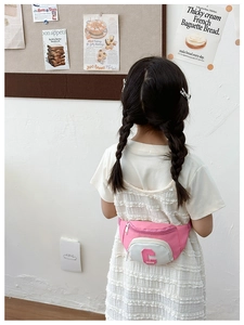 Pink and white patchwork children chest bag with letter C patch shown on a child model