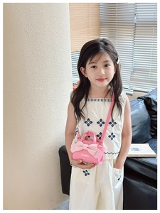 Toddler girl wearing pink crossbody mini bag with large decorative bow and top handle
