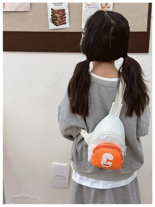 Detailed back view of kids mini crossbody bag in white and orange with letter C patch