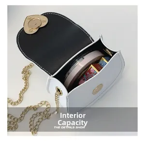 Detail showing the internal capacity of the white heart-lock chain bag for kids