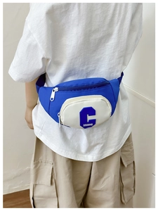 Detail of adjustable woven strap and blue nylon fabric on children crossbody bag