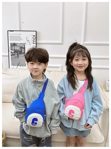 Detail of blue and pink nylon kids chest bags with letter embroidery and zippers