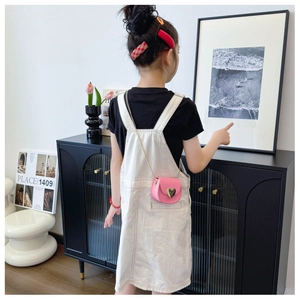 Toddler girl wearing pink mini heart-shaped crossbody bag with gold chain strap detail
