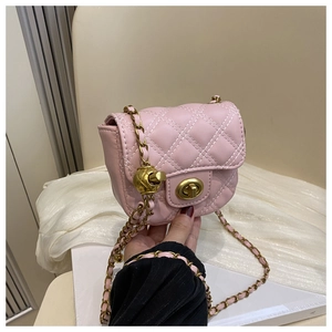 Detail of pink quilted mini crossbody bag with golden chain and ball adjustment