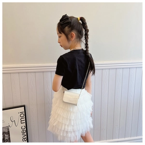 Detail of a white multi-layered lace mesh cake skirt for girls featuring a lightweight design