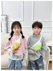 Detail of yellow and green color-block canvas chest bags for kids with letter G