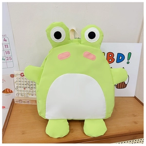 Detail of frog-shaped children backpack in neon green nylon on wooden table