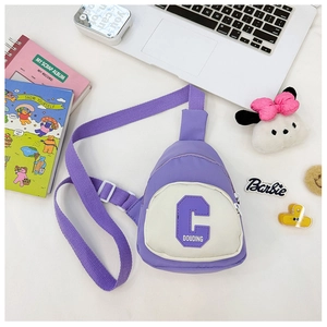 Macro shot of purple nylon chest bag featuring a textured letter C patch with white details