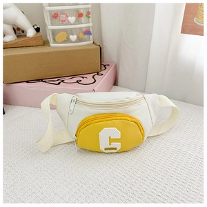 Detail view of stylish kids chest bag featuring yellow contrast pocket and letter C patch