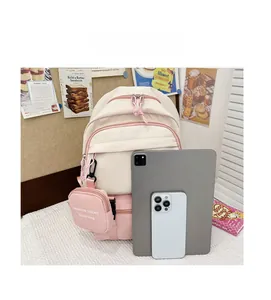 Size comparison of a beige and pink children's backpack with tablet and smartphone