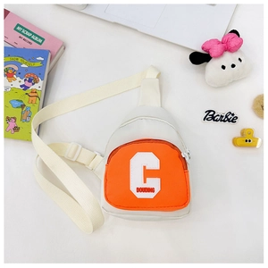 Flat lay of child canvas chest bag with orange zipper pocket and cute accessories