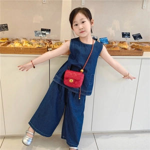Quilted mini chain shoulder bag for kids in vibrant red paired with denim outfit