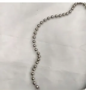Detailed macro view of smooth silver beaded metal shoulder strap chain for shell bags