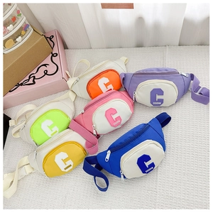 Detail view of colorful canvas chest bags for kids with adjustable straps and letter prints