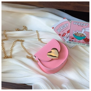 Detailed view of pink heart-shaped metal buckle on a mini faux leather chain bag