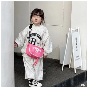 Kids sports set in heather grey with trendy pink crossbody bag worn by child model