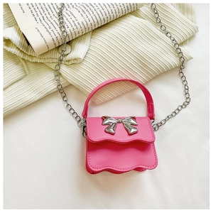 Detail of pink PU leather kids bag with silver bow buckle and wave cut edges