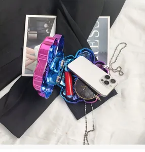Internal view of floral shell clutch showing space for phone and cosmetics