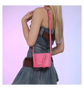Mini bright pink crossbody bag with litchi grain texture and adjustable shoulder strap