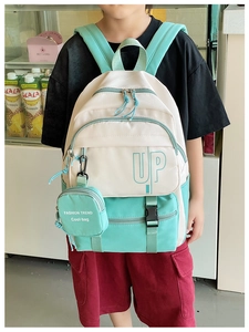 Detail view of stylish kids backpack in off-white and mint green with mini pouch
