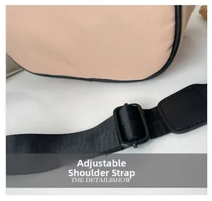 Close-up of beige canvas children's crossbody bag with black adjustable shoulder strap