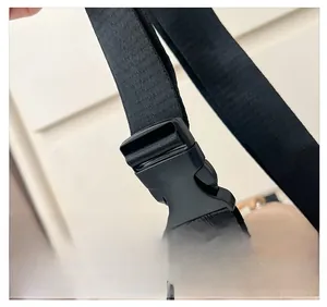 Close-up of durable black plastic buckle and high-density fabric strap on kids bag