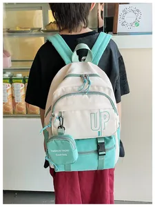 Detail of mint green and beige children backpack with UP logo and mini coin purse