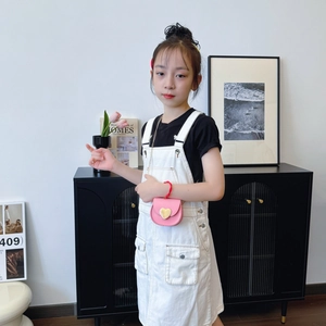 Children's white denim overalls dress with front pockets and pink heart chain bag