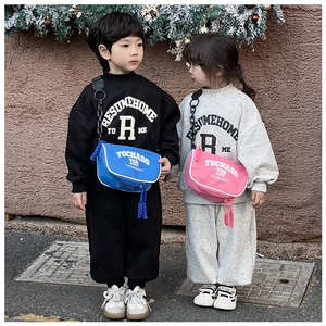 Detail of trendy kids crossbody bag with letter print and casual streetwear style