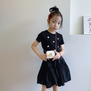 Girl summer outfit set with black bow t-shirt, layered skirt and heart chain bag