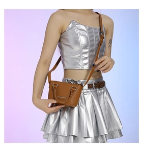 Brown mini crossbody bag with FASHION & BAGS print shown on a model outfit