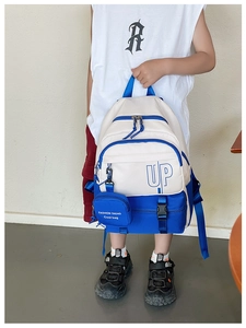 Detail of kids canvas backpack showing the blue and white color block design with UP logo