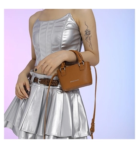 Brown litchi grain mini handbag featuring white fashion text and adjustable shoulder strap