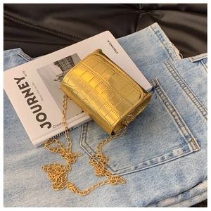 Detailed view of golden crocodile textured kids crossbody bag with metallic chain strap