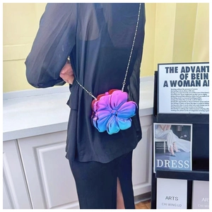 Detail view of flower-shaped crossbody bag with purple and blue metallic gradient finish